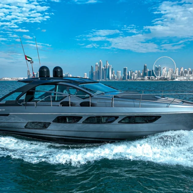 Luxury yacht cruising near Dubai Marina skyline with Ain Dubai in the background