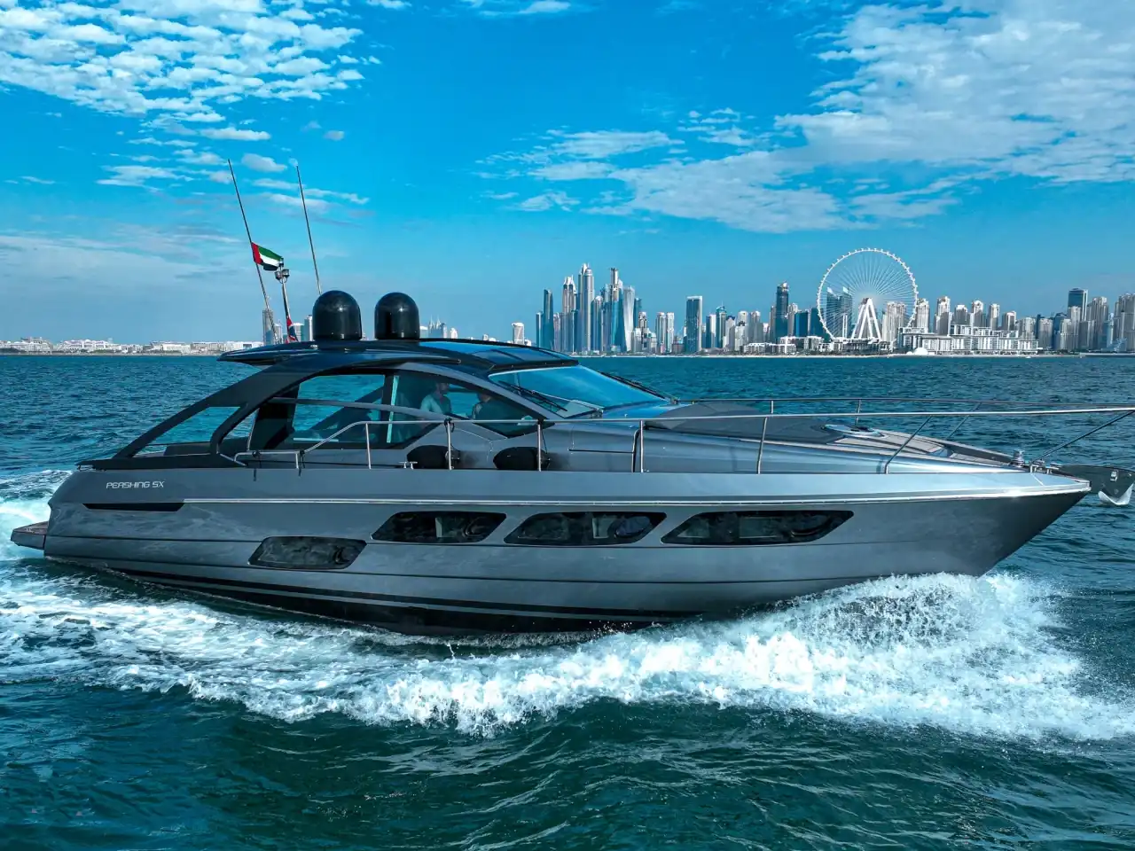 Pershing 5X luxury yacht cruising in Dubai with skyline view for private yacht rental